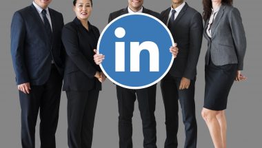 Business people holding a Linkedin logo